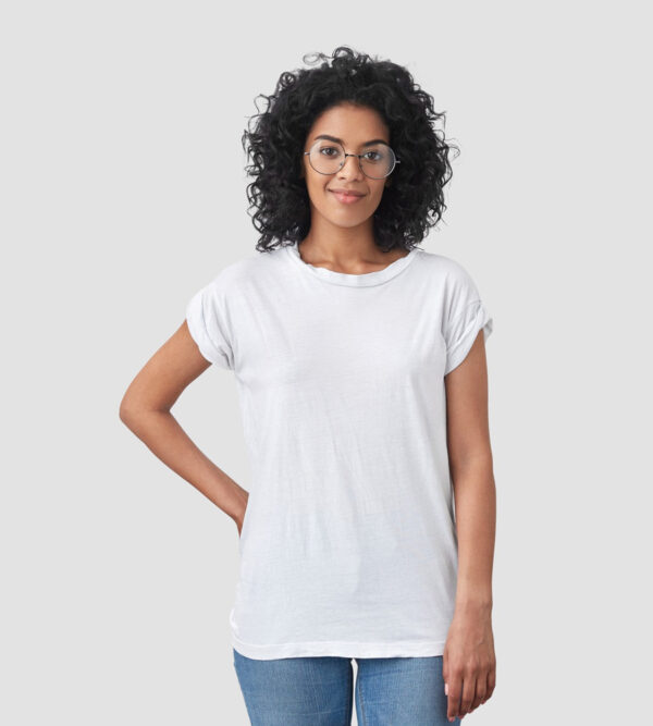 shot beautiful female journalist ready take interview keeps one hand waist has pleased confident expression wears white oversized t shirt jeans spectacles poses blank wall